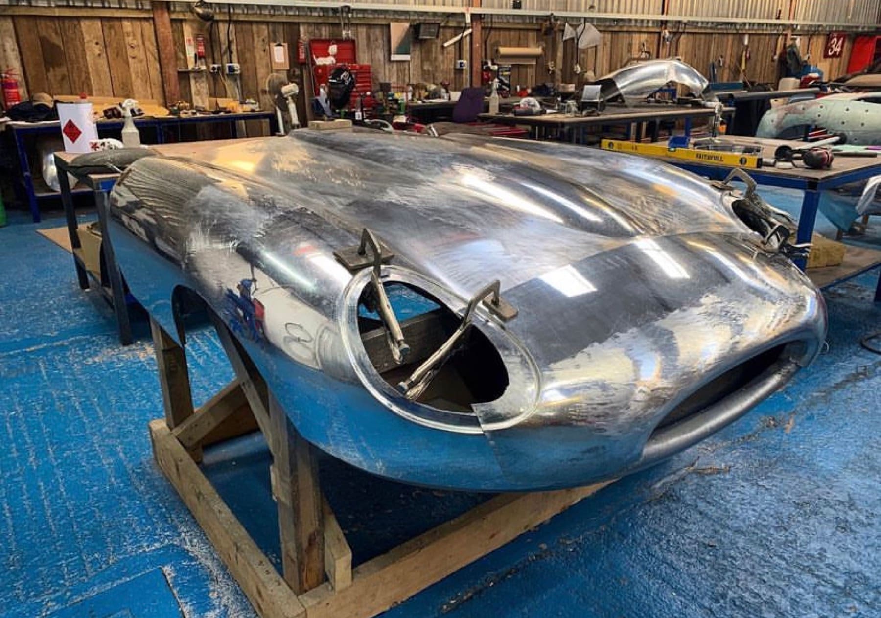 Hand-formed aluminium nose section for a coachbuilt body, mounted on a jig