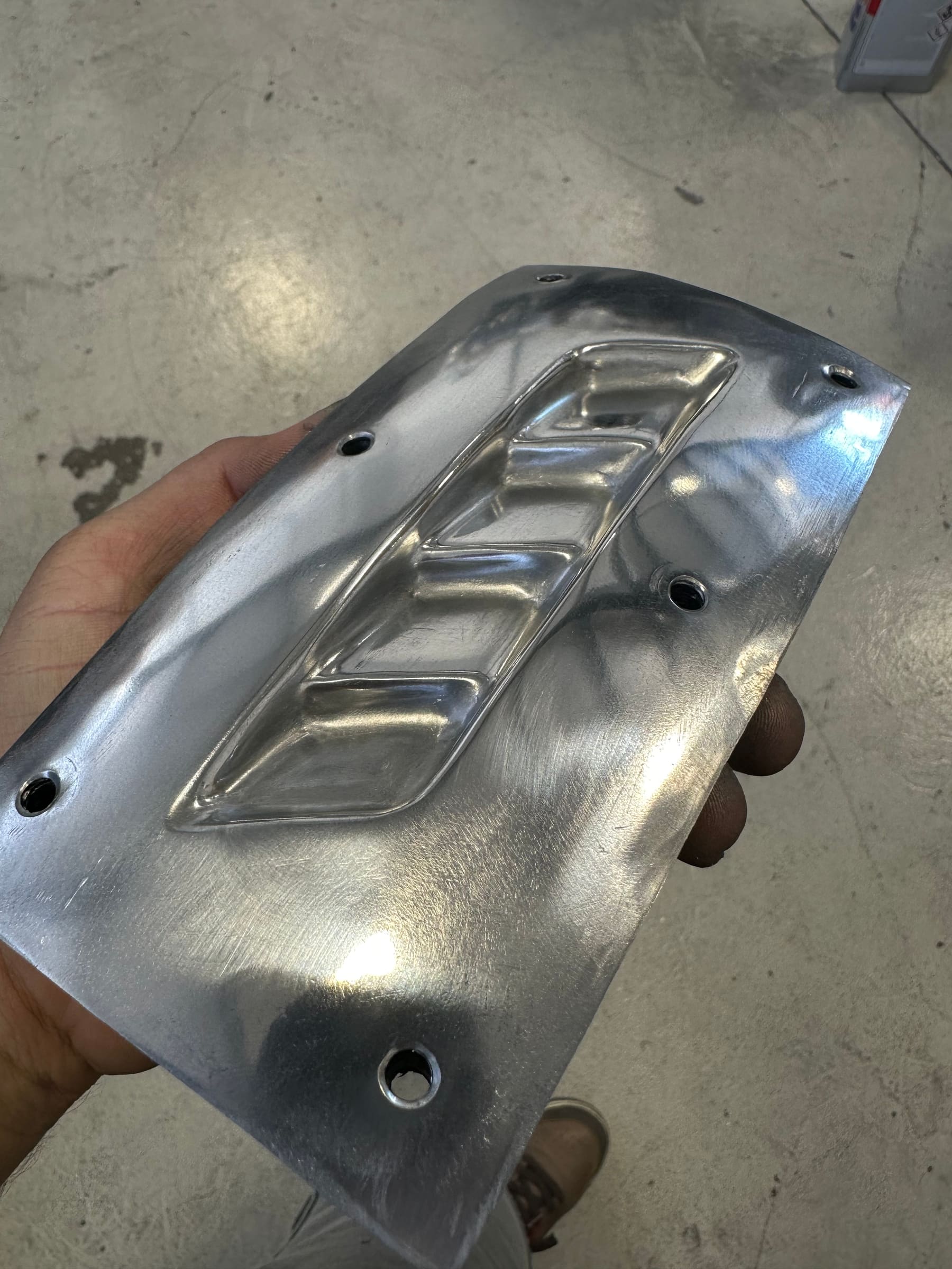 Hand-formed aluminium bracket with pressed louvres, alternate angle