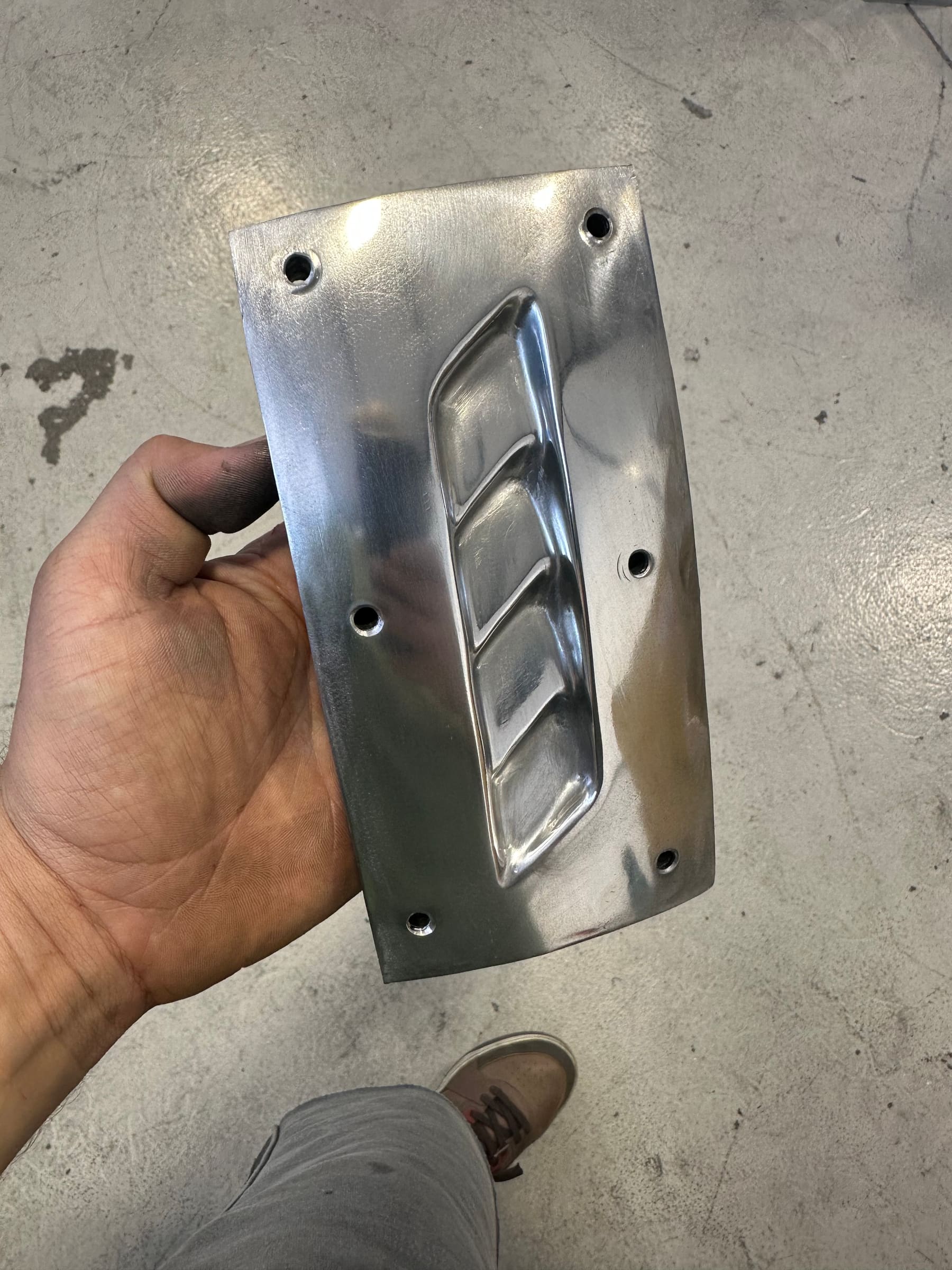 Hand-formed aluminium bracket with pressed louvres and drilled mounting holes