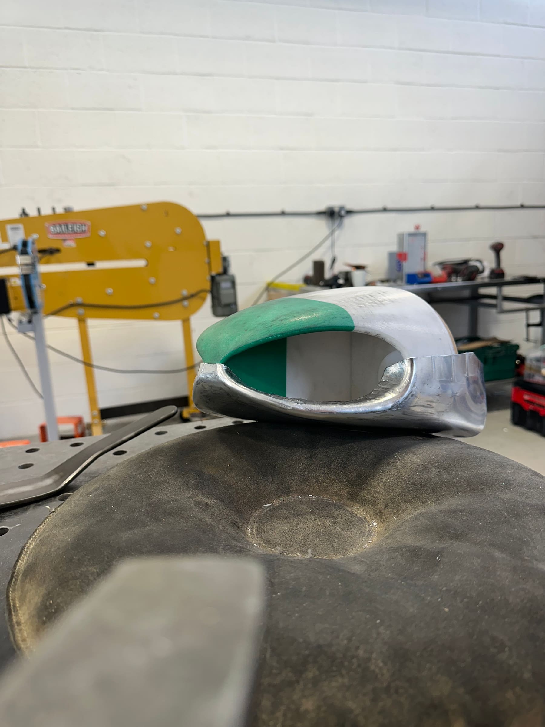 Foam pattern buck alongside the hand-formed aluminium shell shaped from it